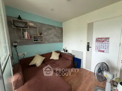 Cozy living room with brown sectional sofa and wall-mounted shelves, perfect for relaxation and reading.