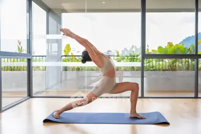 Spacious balcony with glass doors and scenic view, perfect for relaxation and yoga.