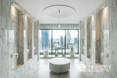 Luxurious marble bathroom with floor-to-ceiling windows offering a panoramic city view, elegantly designed with modern fixtures and a spacious layout.