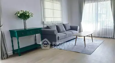 Bright living room with modern gray sofa and elegant decor