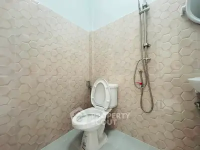 Modern bathroom with hexagonal tile design and sleek fixtures.