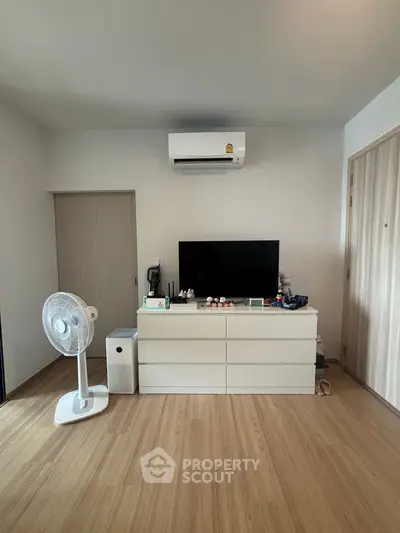 Modern living room with sleek wooden flooring and minimalist decor