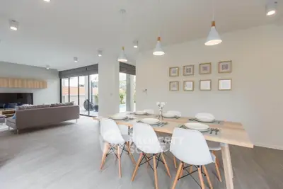 Modern open-plan living and dining area with stylish furniture and natural light