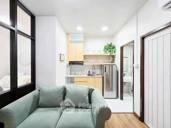 Modern compact living room with open kitchen and cozy decor