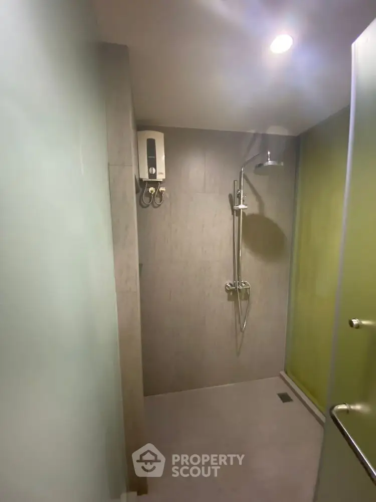 Modern minimalist bathroom with sleek shower and water heater