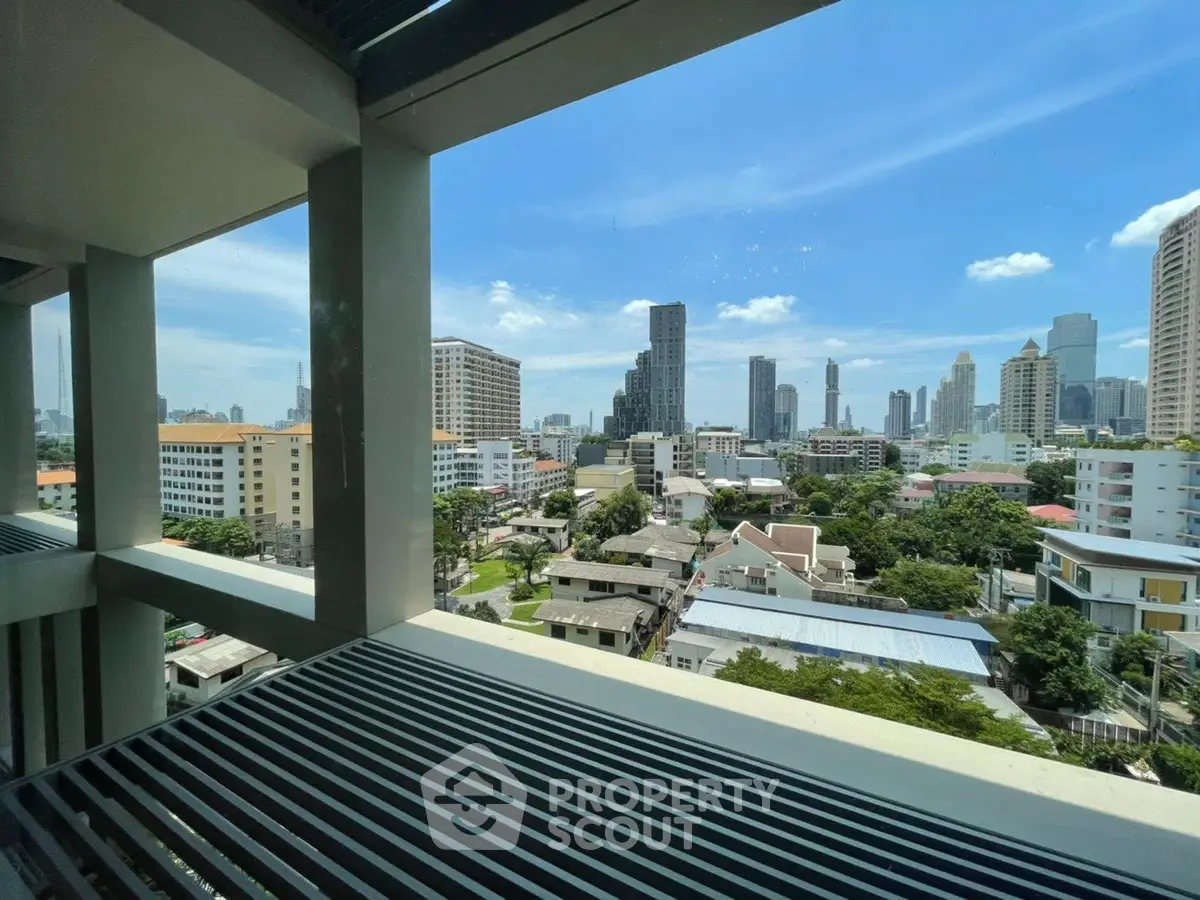 Stunning cityscape view from a modern balcony in a high-rise building.