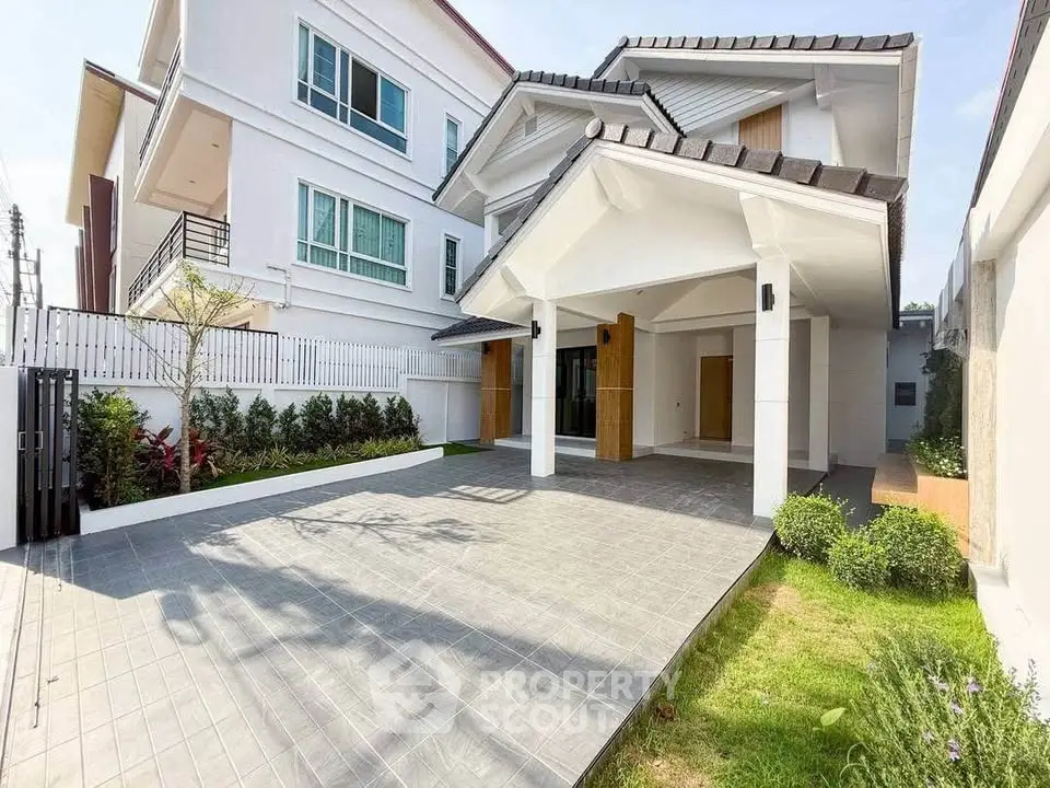 Stunning modern house exterior with spacious driveway and lush garden, perfect for family living.