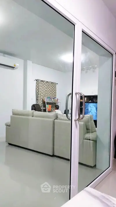 Modern living room with glass sliding doors and stylish furniture