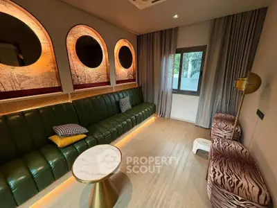 Luxurious living room with unique circular mirrors and stylish seating