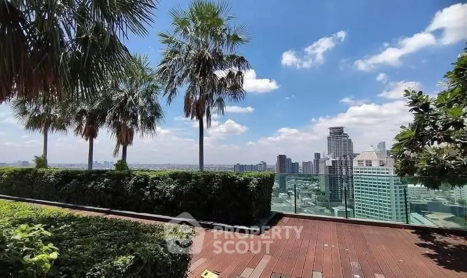 Stunning rooftop garden with panoramic city skyline views and lush greenery.
