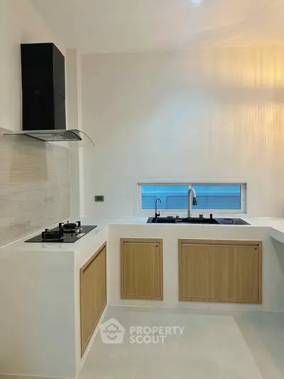 Modern kitchen with sleek design and gas stove, perfect for culinary enthusiasts.