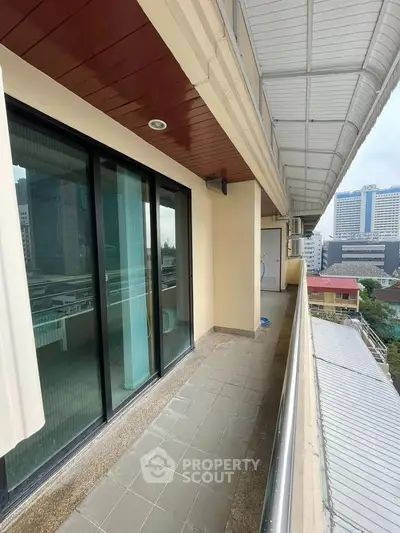 Spacious balcony with city view in modern apartment building