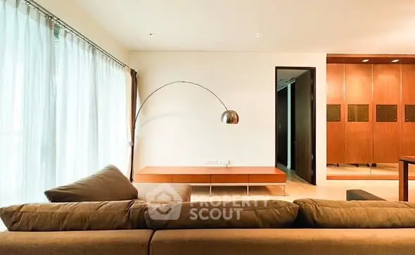 Spacious modern living room with elegant lighting and cozy seating area.