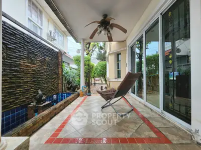 Charming patio with cozy seating and garden view, perfect for relaxation and outdoor enjoyment.
