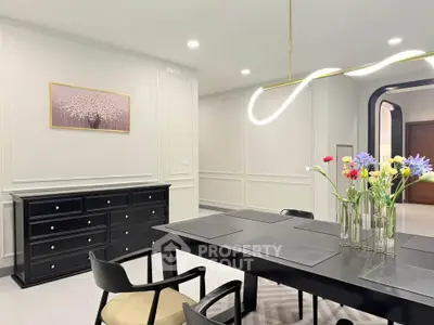 Elegant dining area with modern lighting and floral centerpiece