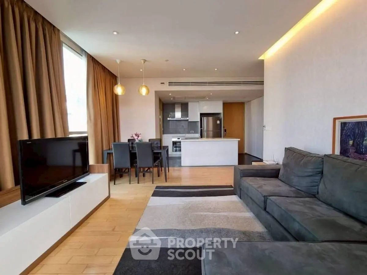 Modern open-plan living room with stylish kitchen and cozy seating area.