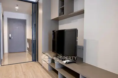 Modern living room with sleek TV unit and open layout in stylish apartment.