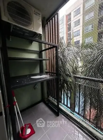 Compact balcony with air conditioning unit and pool view in urban apartment