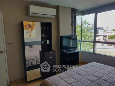 Cozy bedroom with large window and modern decor in urban apartment