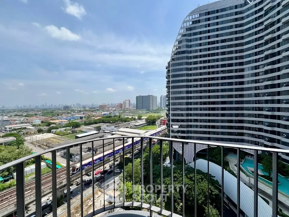 Stunning cityscape view from a modern high-rise balcony, showcasing urban skyline and architectural elegance.