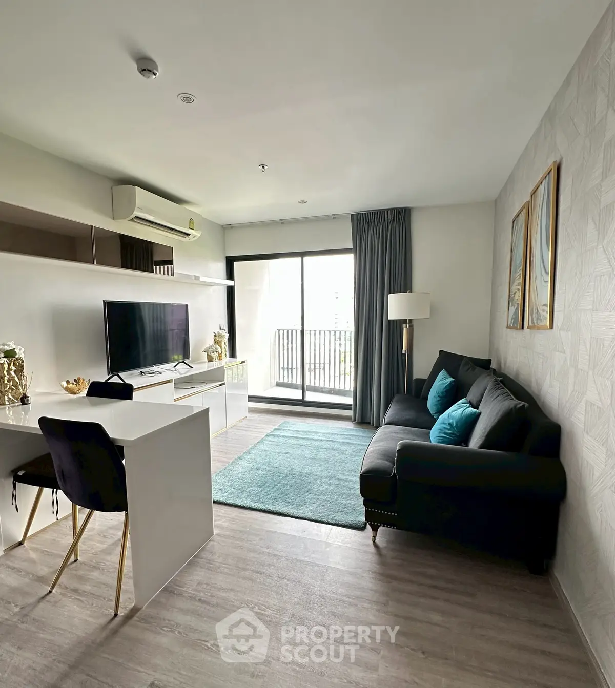 Modern living room with balcony access, featuring sleek furniture and natural light.
