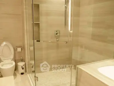 Luxurious modern bathroom with glass shower and elegant fixtures