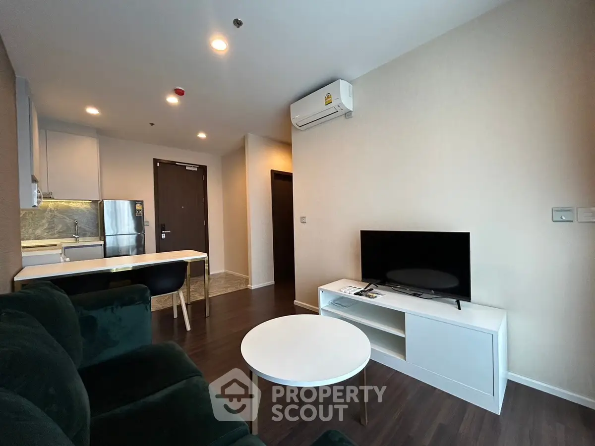 Modern living room with sleek furniture and open kitchen layout