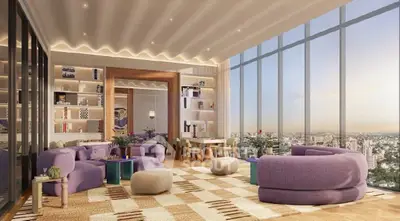 Luxurious living room with panoramic city views and modern decor in high-rise apartment.