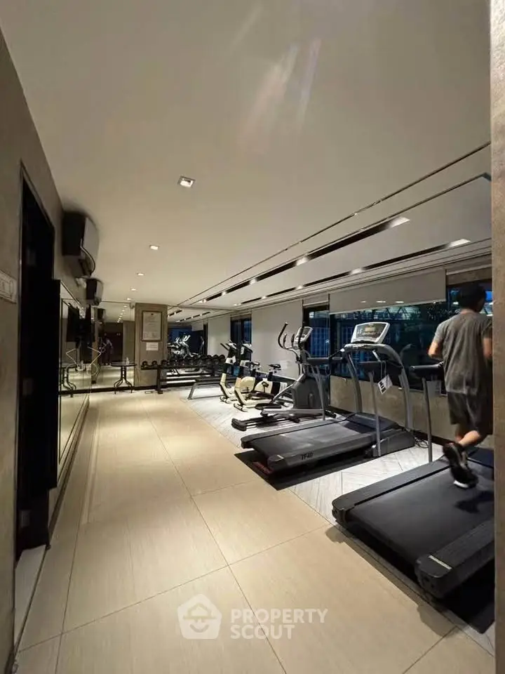Modern gym with state-of-the-art equipment in luxury residential building.