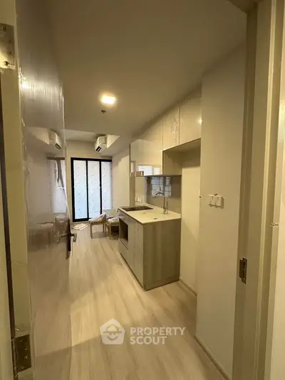 Modern kitchen with open layout and sleek design in a contemporary apartment.