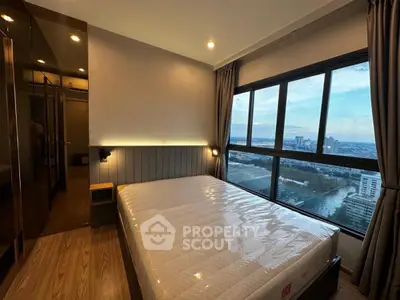 Modern bedroom with large window offering stunning city view