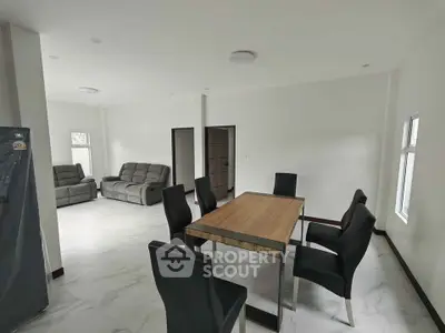 Spacious modern living and dining area with sleek furniture and natural light.