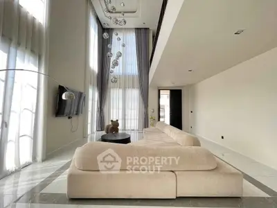Luxurious modern living room with high ceilings and elegant decor