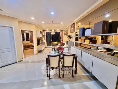 Spacious open-plan living and dining area with modern decor and large windows.