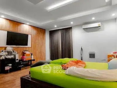 Spacious bedroom with modern decor and vibrant bedding