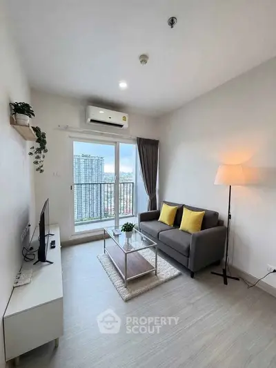 Modern living room with city view, featuring sleek furniture and large windows for natural light.