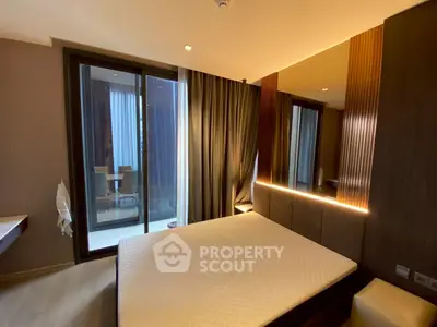 Modern bedroom with large window and stylish lighting