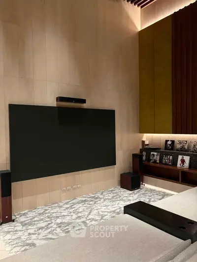 Luxurious home theater with modern design and large screen, perfect for entertainment enthusiasts.