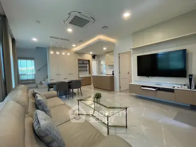 Spacious modern living room with open kitchen and elegant decor