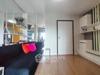 Modern living room with stylish decor and vibrant cushions in a contemporary apartment.