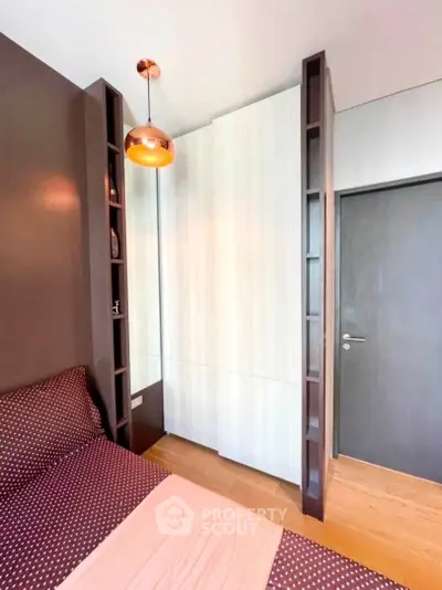 Modern bedroom with stylish lighting and built-in wardrobe