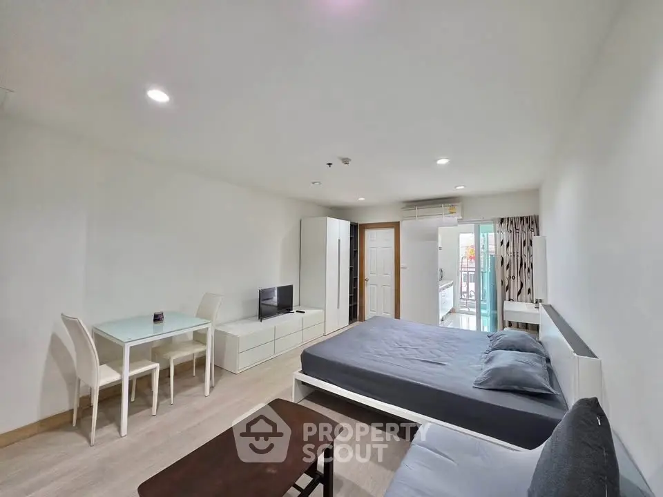 Spacious modern bedroom with minimalist decor and natural light