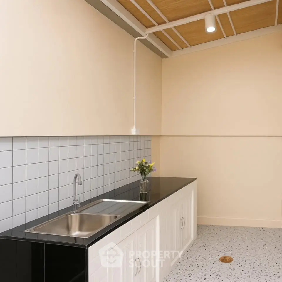 Modern kitchen with sleek black countertop and minimalist design