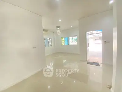 Spacious and bright living room with modern lighting and tiled flooring