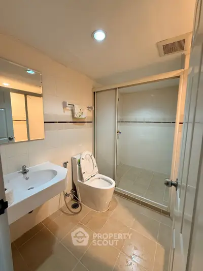 Modern bathroom with sleek fixtures and spacious shower area