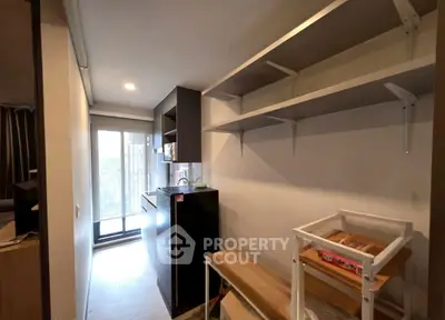 Compact kitchen with open shelving and small appliances in modern apartment