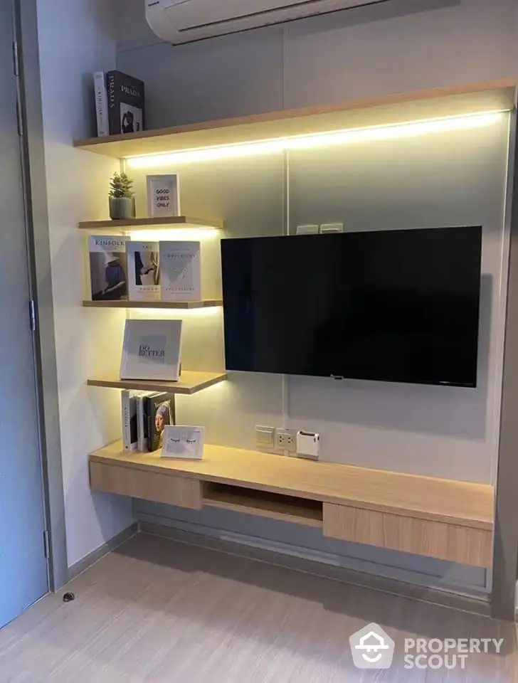 Modern living room with wall-mounted TV and ambient lighting, featuring sleek wooden shelves and a minimalist design.