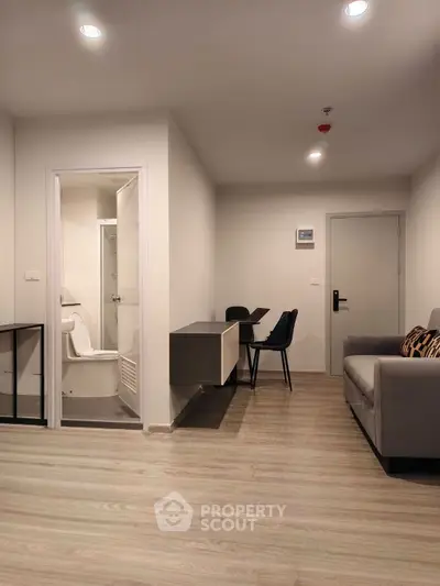 Modern apartment interior with cozy living area and compact bathroom