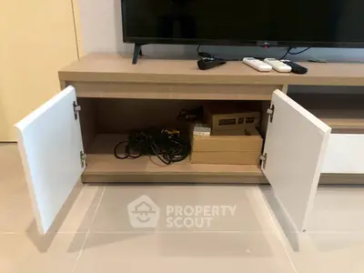 Modern living room with sleek TV stand and open storage cabinets