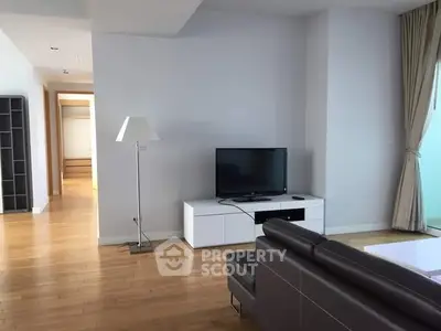 Spacious modern living room with sleek furniture and natural light.
